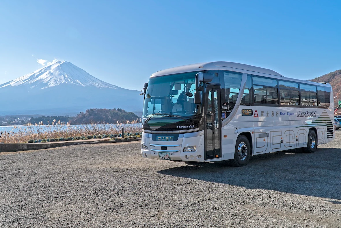 Fujikyu Resort Express highway coach parked with Mount Fuji rising behind it